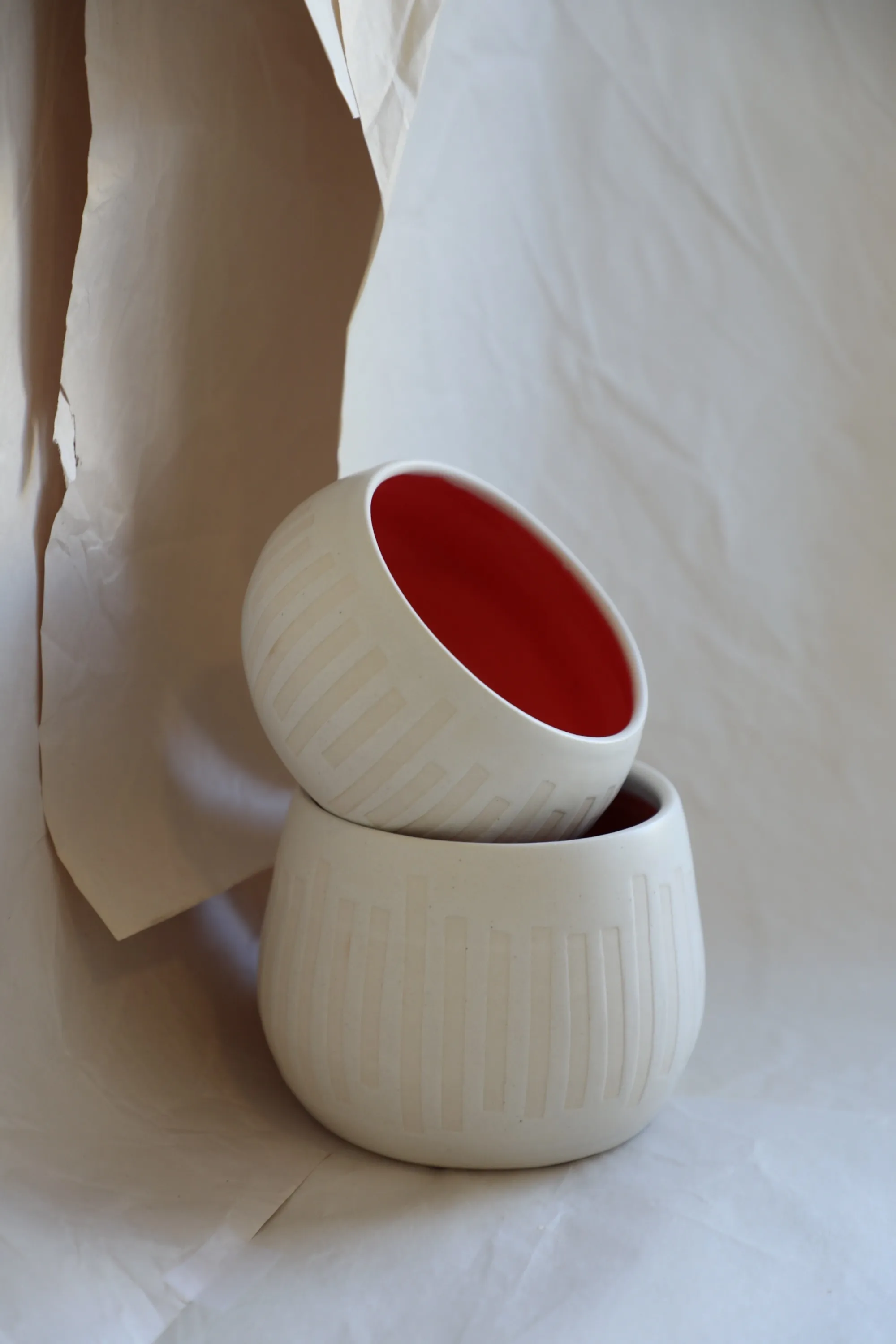 Geometric Bowls, Stoneware, incised geometric pattern, red interior glaze, 2023