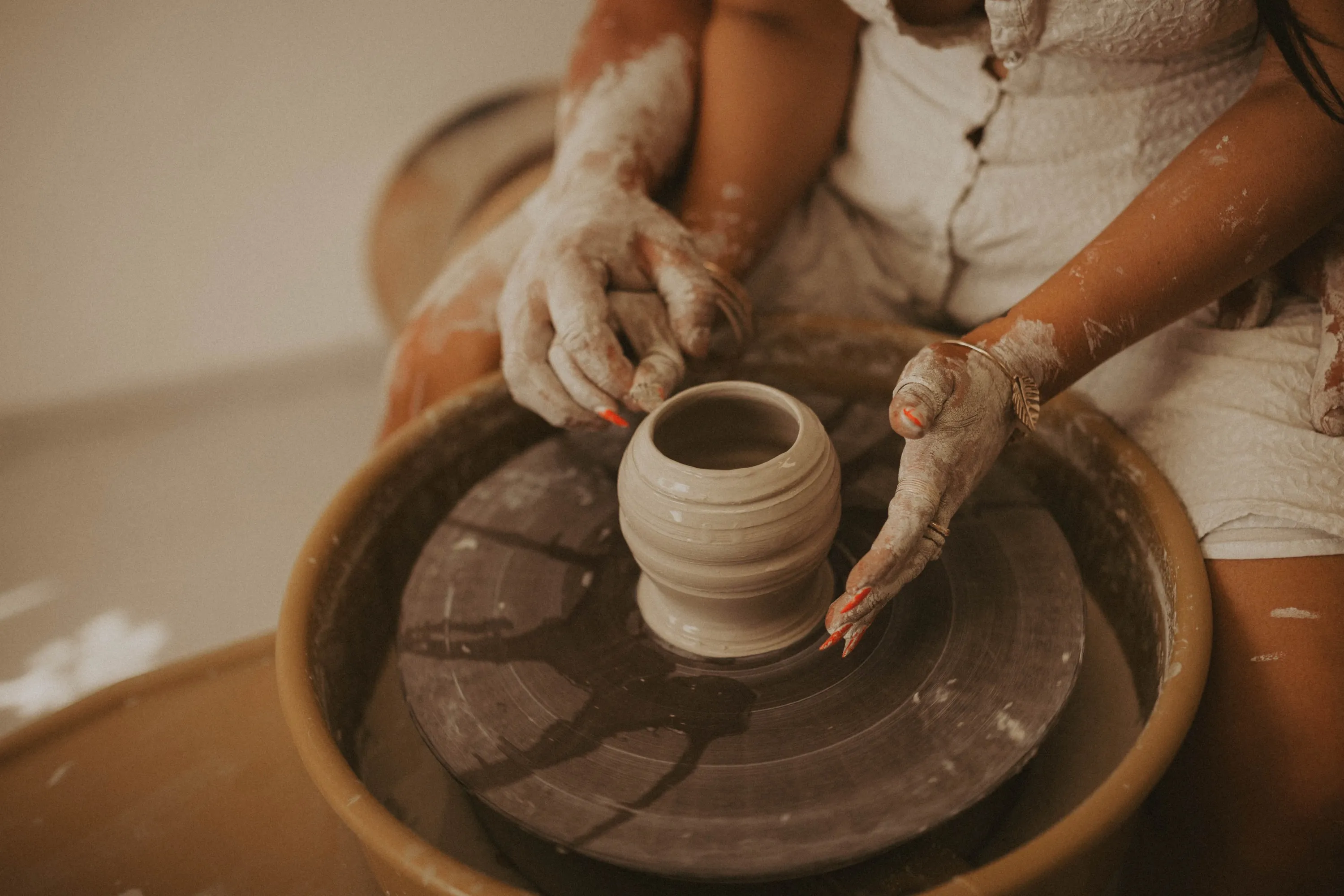 Two sets of hands on the wheel during a workshop session
