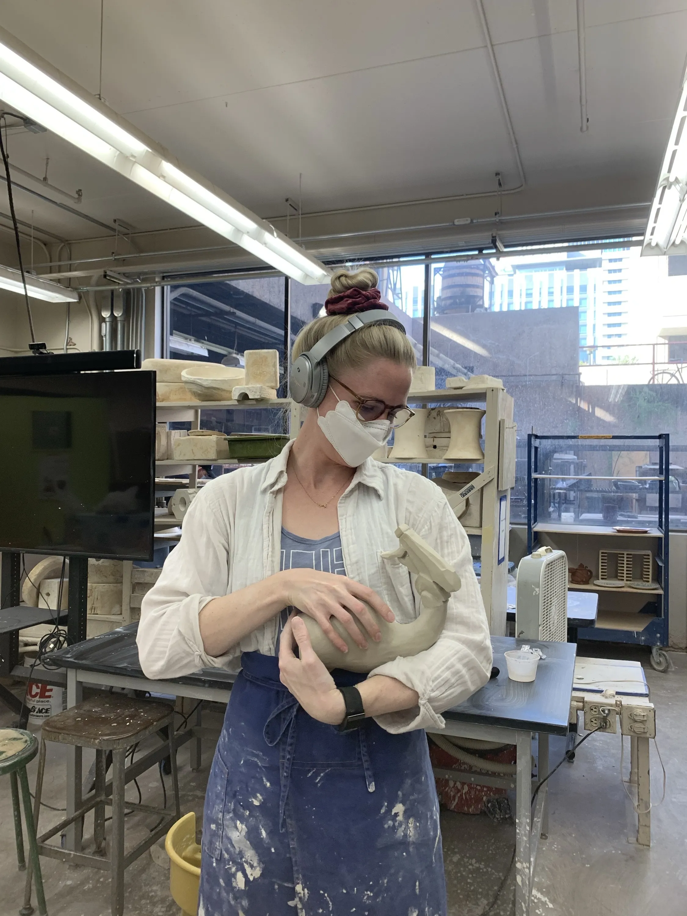 Sarah holding a spray bottle sculpture in the ASU studio