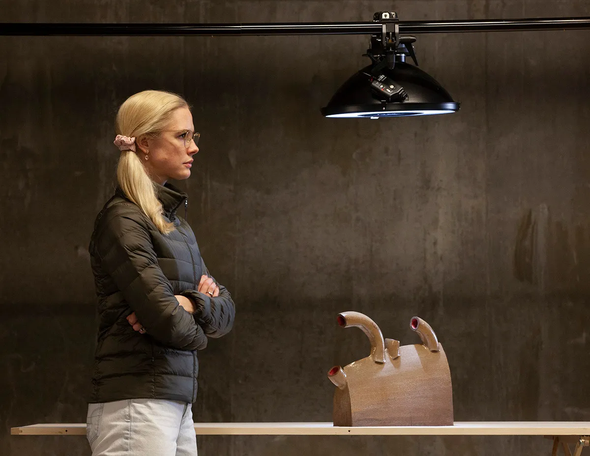 Sarah photographing a sculpture under studio lights
